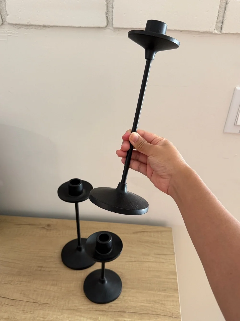 Set of three black metal taper candle holders